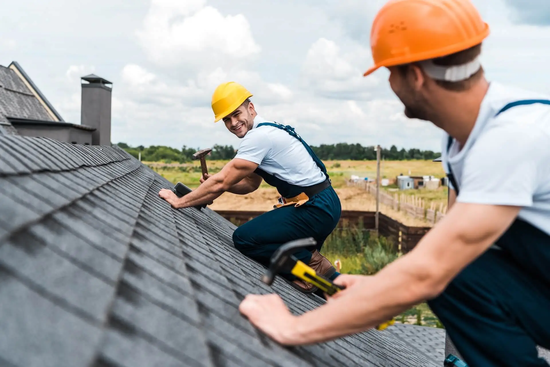 selective focus of happy repairman looking at cowo Residential Roofing